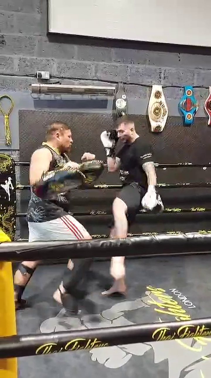 Darius Skliaudys sparring in the ring at Thai Fighters, championship belts on the wall behind