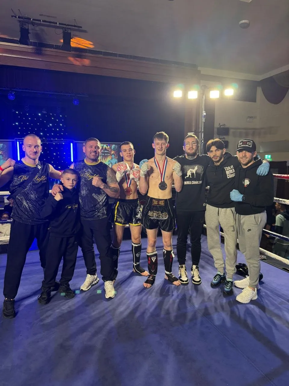 The team together at a fight night with medals
